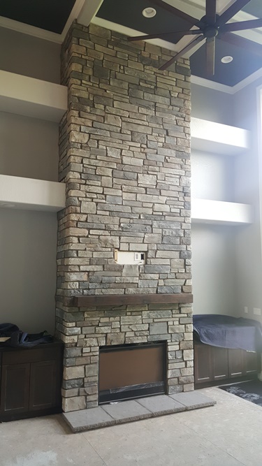 Floor to ceiling stone fireplace